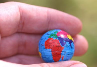 Hand holding globe showing Africa Hand holding globe showing Africa
