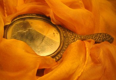 Handheld mirror laid on fabric Handheld mirror laid on fabric