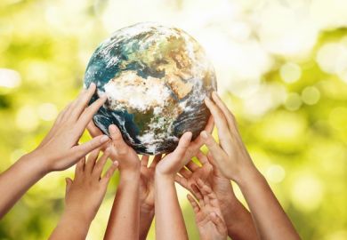 Many hands holding up the Earth, symbolising collaboration to meet the SDGs