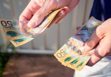 Hands holding australian dollars to make a payment