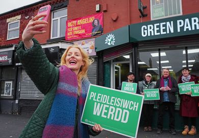 Green Party candidate Hannah Spencer takes a selfie with supporters outside the campaign headquarters on 18 February, 2026 at the Green Party offices in the Gorton area of Manchester, England.