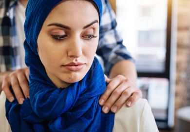 A Muslim woman with male hands on her shoulders, signifying sexual harassment in the Middle East