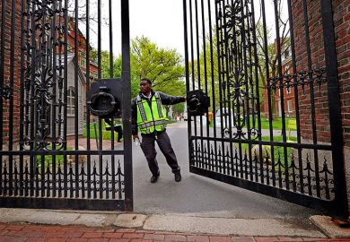 A security guard closing the Johnston Gate at Harvard University. As an illustration that Trump’s anti-DEI agenda ‘already having grave impact’, with some institutions shut down initiatives or continue them in a different guise.