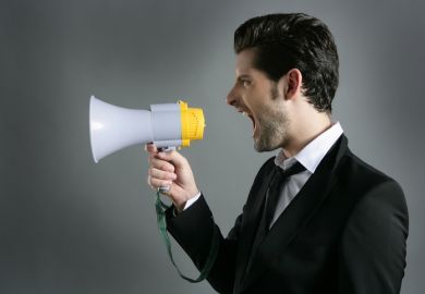 A man shouting into a megaphone, illustrating heckling