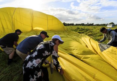 Helping the ground crew folding up the balloon