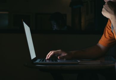 Man working on his computer laptop in night