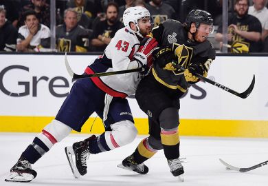 two ice hockey players in tackle