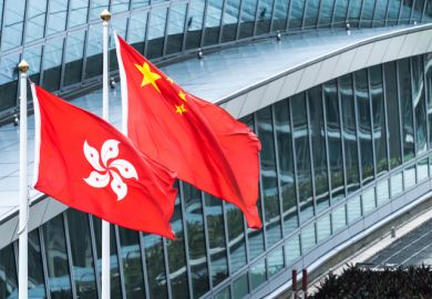 Hong Kong and mainland China national flags stand together