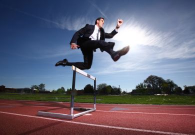 Businessman jumping a hurdle Businessman jumping a hurdle