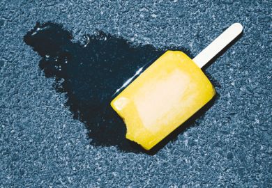 Ice lolly melting on pavement concrete