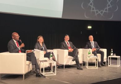 Four panelists sitting on a stage at the THE Europe summit 