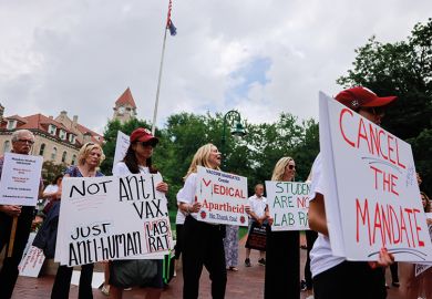 Anti-vaxxers and anti-maskers gathered at Indiana University’s Sample Gates to protest against mandatory Covid vaccinations