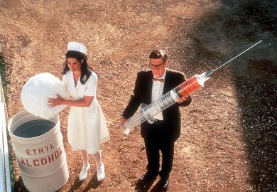 Nurse and man holding giant syringe Nurse and man holding giant syringe