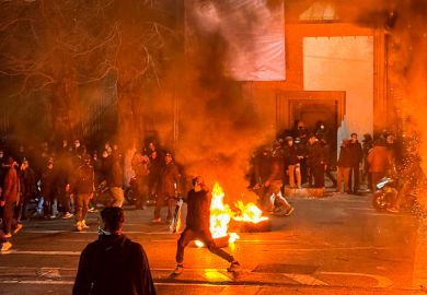 Iranian protestors block a street during a protest in Tehran on January 9