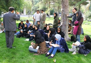 An Iranian professor wags his finger at students