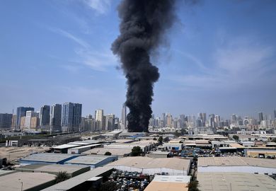 A black plume of smoke rises from a warehouse at the industrial area of Sharjah City in the United Arab Emirates following reports of Iranian strikes in Dubai, United Arab Emirates, Sunday, 1 March, 2026.