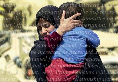 Iraqi woman holding and protecting child in front of army tanks