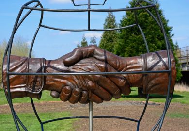 Christmas Truce Memorial showing soldiers handshake within a globe, National Memorial Arboretum, Alrewas, Staffordshire, England, UK Christmas Truce Memorial showing soldiers handshake within a globe, National Memorial Arboretum, Alrewas, Staffordshire, England, UK
