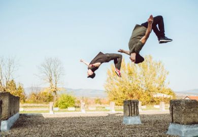 Two people perform backflips illustrating flipped classroom model
