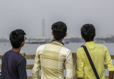 Group of three friends having fun at sunset time.