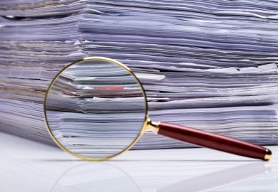 Close-up Of Magnifying Glass On Background Of Stacked Paper Files