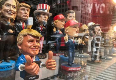 Bobble head dolls of various political figures are seen on a gift shop's window display.