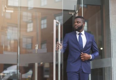 Businessman in formal suit walking out of modern office Businessman in formal suit walking out of modern office