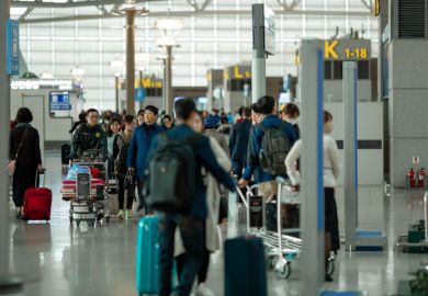 People with suitcases and luggage carts at Incheon International Airport