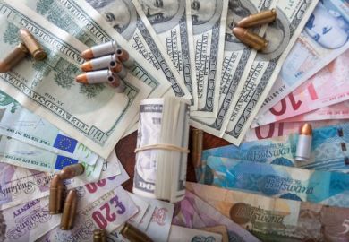 Various countries' money splayed in a circle, with bullets lying on top