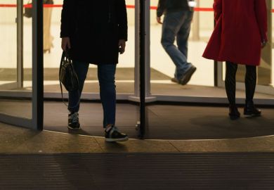 People leaving an office via a revolving door People leaving an office via a revolving door