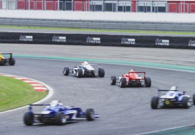 Blurred motion of Formula cars driving on track