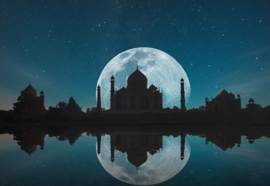 Taj Mahal silhouetted against the moon and reflected in water