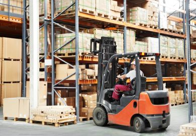 Warehouse worker in uniform loading boxes by forklift warehouse worker in uniform loading boxes by forklift to show lift and shift in transnational education