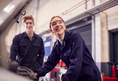 Students looking at car engine on auto mechanic apprenticeship course
