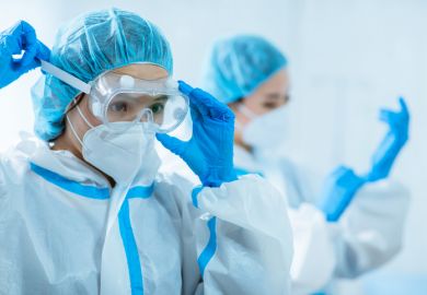 Doctors wear protective suits