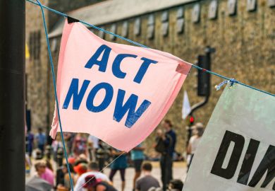"Act now" banners in a climate change protest in Cardiff city centre.