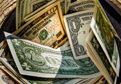 Straw hat with a stack of dollar bills inside Straw hat with a stack of dollar bills inside