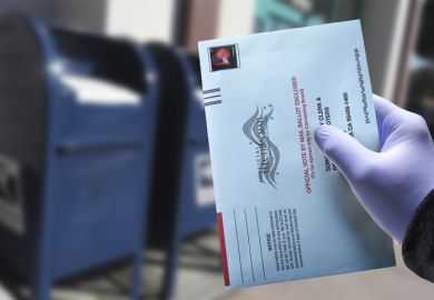 Person drops ballot into ballot box