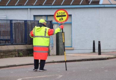 Lolly pop man holding "stop" sign 