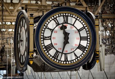 Close up of large hanging 4 sided clock face in Waterloo Station