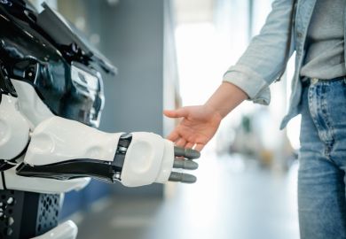 A man shakes hands with a robot