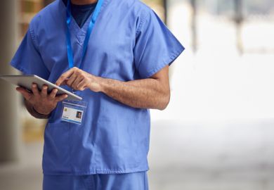 Close Up Of Male Medical Worker In Scrubs With Digital Tablet In Hospital Close Up Of Male Medical Worker In Scrubs With Digital Tablet In Hospital