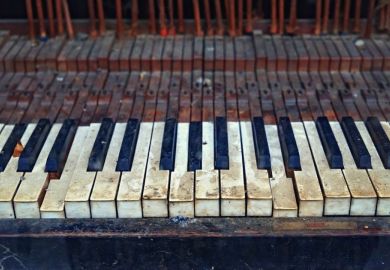 The keyboard of an old vintage piano in ruined condition