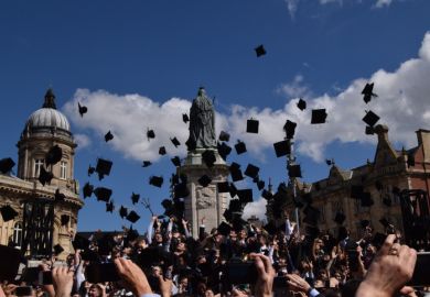 Graduates receive their diplomas in a ceremony at Hull City Hall, UK