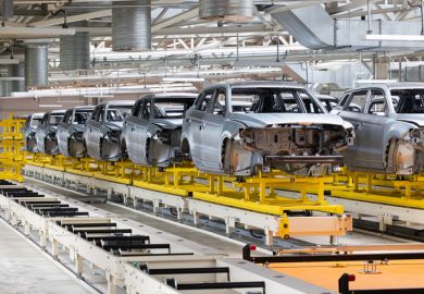 Partially built cars on production line Partially built cars on production line