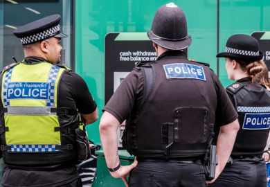 Three Police Officers Standing Patrolling For Public Safety Three Police Officers Standing Patrolling For Public Safety