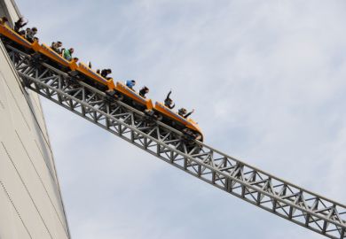 People riding rollercoaster at amusement park