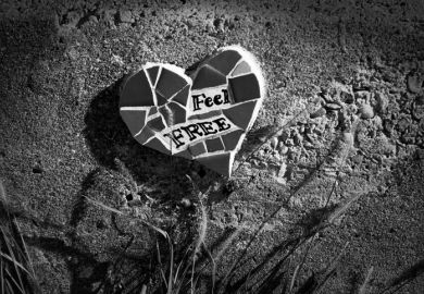 Heart-shaped mosaic reads “feel free” in New Orleans, after Katrina, illustrating a review of “Conflict Graffiti” by John Lennon