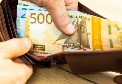 Open wallet with Norwegian kroner notes