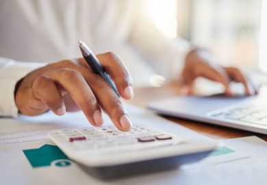 man on a computer and calculator